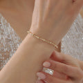 GOLD GLÄNZENDES KUGELDESIGN MIT KNOCHEN-OPTIK ARMKETTE | 14K GOLD