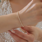 DORICA-KUGEL-REIHENOHRRINGE ARMKETTE | 14K GOLD
