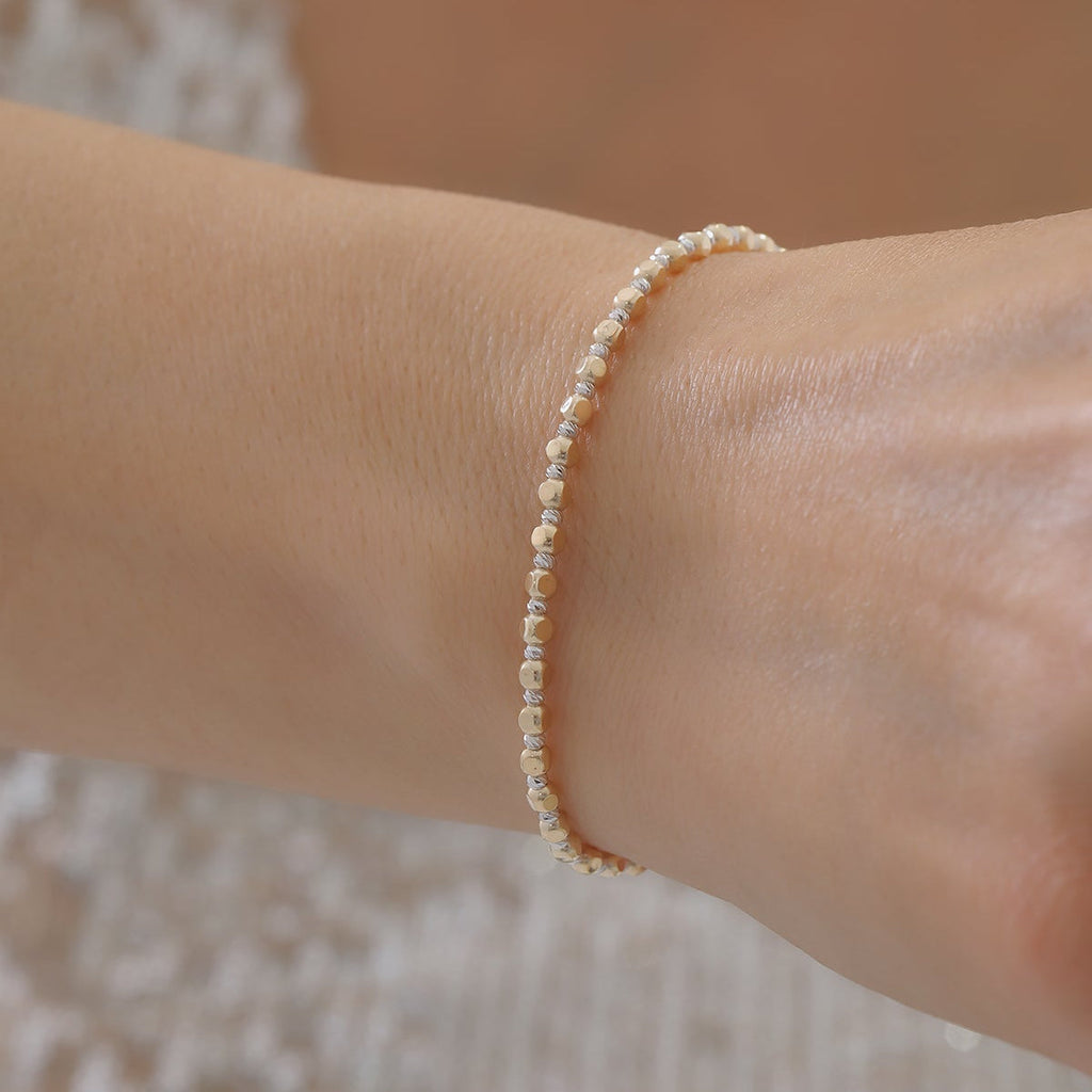 DORICA-KUGEL-REIHENOHRRINGE ARMKETTE | 14K GOLD