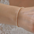 DORICA-KUGEL-REIHENOHRRINGE ARMKETTE | 14K GOLD