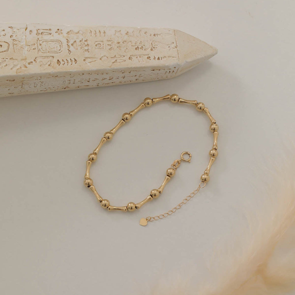 GOLD GLÄNZENDES KUGELDESIGN MIT KNOCHEN-OPTIK ARMKETTE | 14K GOLD