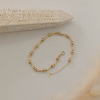 GOLD GLÄNZENDES KUGELDESIGN MIT KNOCHEN-OPTIK ARMKETTE | 14K GOLD
