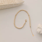 DORICA-KUGEL-REIHENOHRRINGE ARMKETTE | 14K GOLD