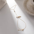 PERLENVOGEL-FEDER HANDKETTE | 14K GOLD
