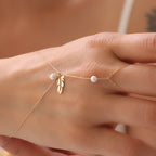 PERLENVOGEL-FEDER HANDKETTE | 14K GOLD